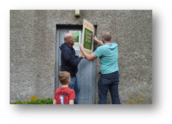 I'm not sure what they put these for sale signs up with but this one required two grown men and a very small one to theatrically rip it from the building.