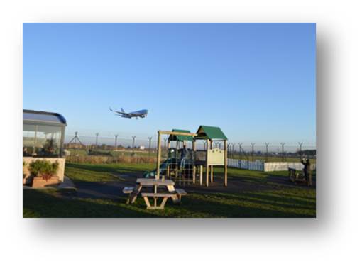 An aircraft coming in to land at Manchester Airport taken from the Airport bar
