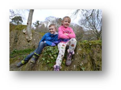 Adam and Emily chill out after climbing the mud-mountain and tree roots