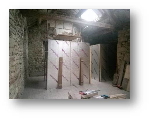 Roughing out the layout of the bunk room and height of the mezzanine floor with insulation panels and scaffolding