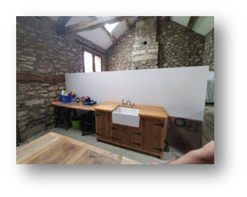 The sink unit Rachel found online next to the temporary worktop (left) and the cellar access (right)